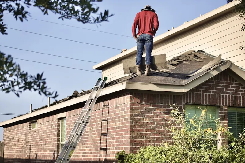 Professional roofer working on a residential roof in Palmetto Bay
